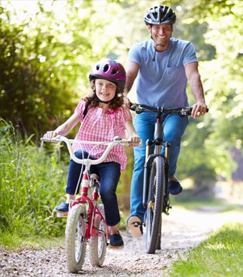 Activities for People with Arthritis - Family cycling in the sun