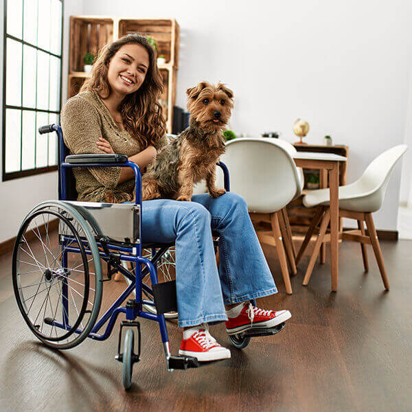 How Pets Benefit Disabled - Disabled woman in wheelchair with her pet dog