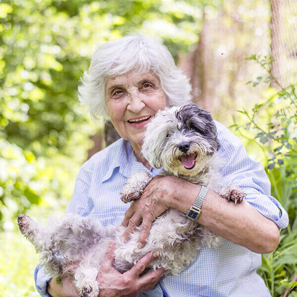 How Pets Benefit Disabled - Elderly lady with her pet dog smiling