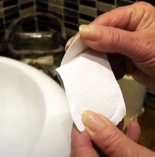 Peeling anti slip bath sticker off backing