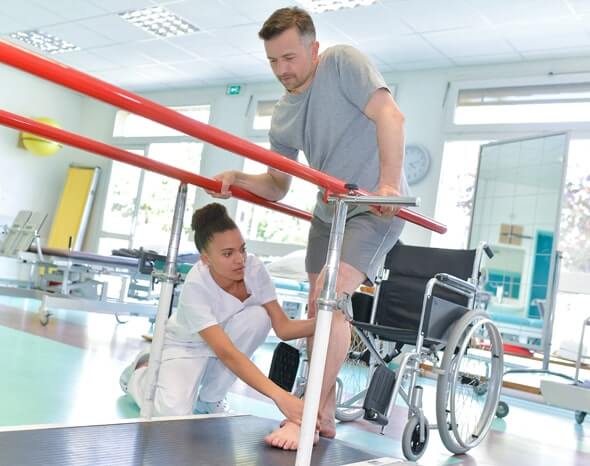 Physiotherapist Treating Patient Who is Struggling with Activities of Daily Living