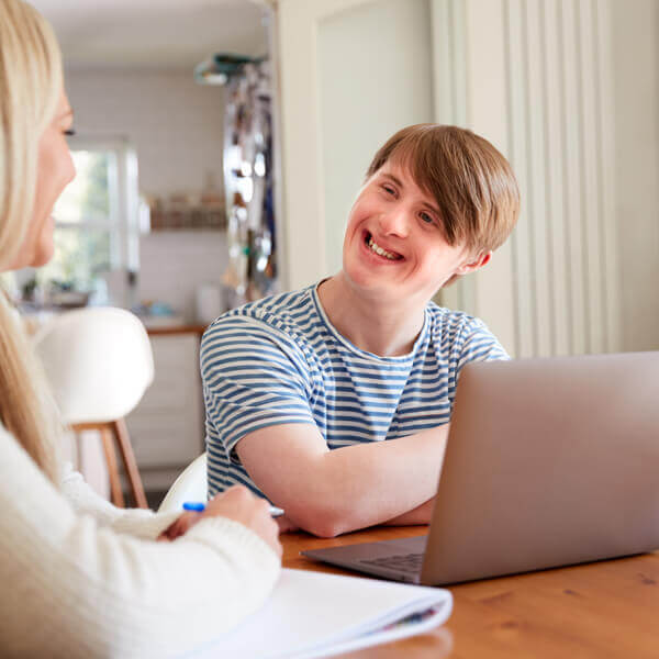 Woman with Down Syndrome Using a Laptop to browse Webste Accessibility Websites